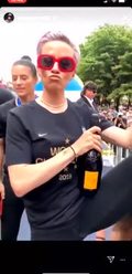 Rapinoe with a Bottle of Veuve in One Hand and the World Cup Trophy in the Other Shouting ‘I Deserve This’